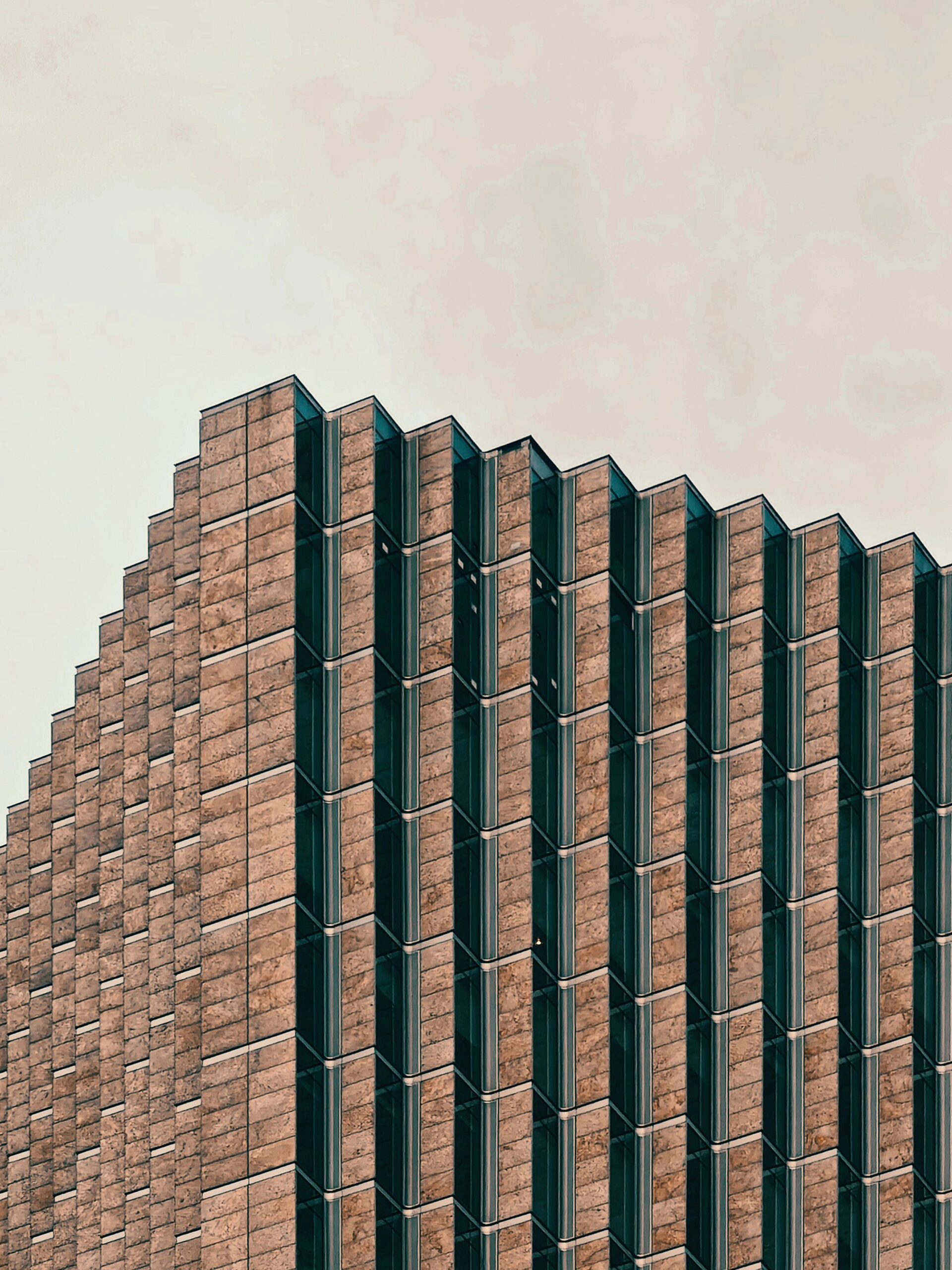 Close-up of a modern building with a unique geometric facade and repeating patterns.